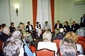 A group of people sitting in chairs and talking.