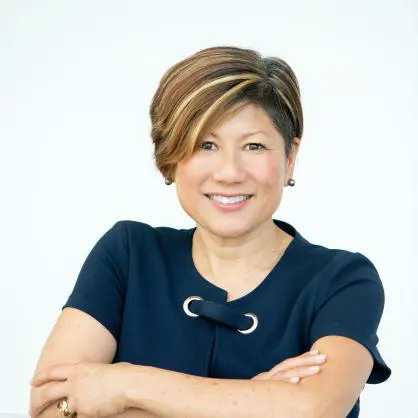 A woman with short hair is smiling for the camera.